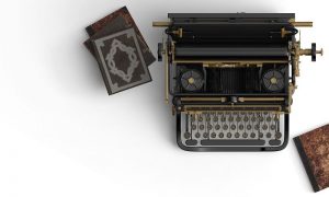 Old-fashioned typewriter with books